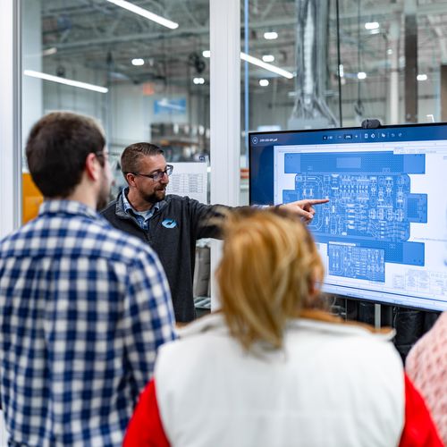 Expert team of engineers collaborating on design for manufacturability 